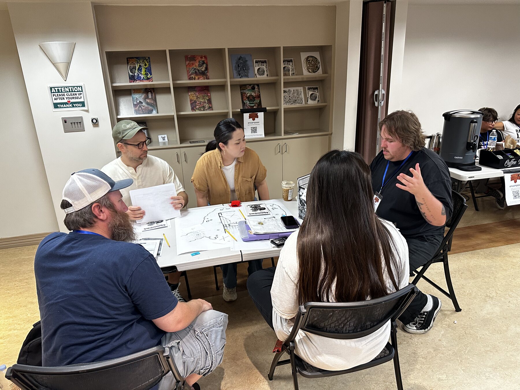 Players at a Mighty Deeds Summer 2026 game table