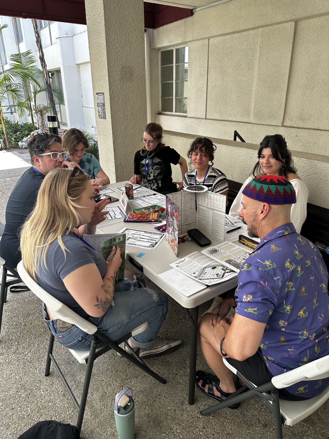 Players at an outdoor Mighty Deeds Summer 2026 game table